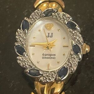 Gold and Silver Ornate Watch with Blue Gem Accents